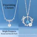 Elegant sweet floral necklaces featuring pearl and blue butterfly crystal pendants in silver finish. - Floral Cluster & Butterfly Flower (Set of 2)