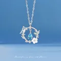 Elegant silver necklace featuring a butterfly and flower pendant with a blue teardrop stone - Butterfly Flower