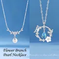 Elegant silver necklaces featuring pearl branch and blue teardrop butterfly pendants - Floral Branch Pearl and Butterfly Flower