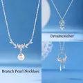 Three elegant silver-tone necklaces set with pearl, dreamcatcher, and floral motifs. - Floral Branch Pearl and Dreamcatcher and Fanghua