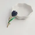 Detailed close-up of an elegant blue tulip brooch with green leaf and rhinestones - Dark Blue