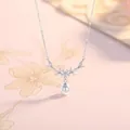 Silver floral crystal necklace with white pearl drop pendant on cream background - Flower Cluster