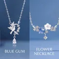 Elegant silver-toned necklaces featuring delicate bird and flower charms with blue stones - Bird and Eucalyptus And Eternal Flower