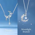 Elegant silver crescent moon necklace featuring blue opal star and crystal charms - Moon and Branch Duo