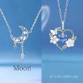 Elegant silver necklaces with crescent moon and floral heart pendants with blue stones - Moon and Heart Duo