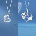 Elegant silver moon and heart pendant necklaces with blue gemstones and flowers - Branch and Heart Duo