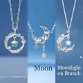 Elegant silver crescent moon and feather necklace set featuring glowing moonstone accents - Feather Moon and Branch Trio