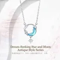 Detailed view of silver star and moon necklace with light blue crescent pendant - Star and Moon Dream Style / Silver