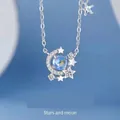Dromerige zilveren ster en maan ketting met een glanzende blauwe edelsteen hanger - Sterren Rond de Maan Stijl