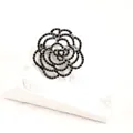 Elegant vintage hollow rose brooch set with black rhinestones on a white textured base - Black