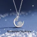 Elegant silver-toned crescent moon necklace with an icy blue snowflake charm pendant - Snowflake