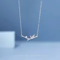 Elegant silver bamboo pendant necklace with sparkling crystals on deep blue backdrop - Bamboo