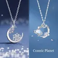 Silver-tone celestial necklace featuring snowflake and planet pendants with blue crystals - Snowflake & Cosmic Planets