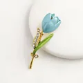 Macro view of blue enamel tulip brooch detailing rhinestones and golden stem texture - Lake Blue