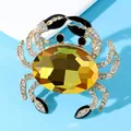 Macro shot of a luxury crab brooch with large yellow crystal and rhinestone detailing - Yellow