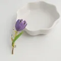 Detailed macro view of an elegant purple enamel tulip brooch with rhinestone accents - Purple