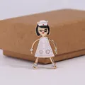 Charming enamel nurse brooch with faux pearl details on a neutral gift box background - White