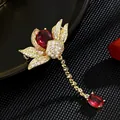 Detailed macro shot of vintage gold-plated lotus brooch featuring sparkling red crystals - Gold Lotus Red Stone