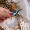 Detailed shot of a blue and white enamel umbrella brooch with gold starfish accent - Umbrella Shape (Umbrella) / Blue and White Umbrella
