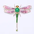 Close-up detail of a colorful enamel dragonfly brooch featuring sparkling crystal accents - Purple