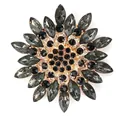 Vintage style glass snowflake brooch with dark grey and black stones in gold setting. - Black