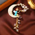 Exquisite vintage enamel brooch featuring a crescent moon and fairy with iridescent pearls. - Moon Fairy Tassel Style (10)