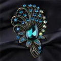 Elegant vintage palace style emerald green crystal brooch with sparkling blue rhinestones - Green