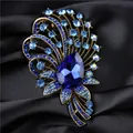 Luxury vintage style crystal brooch featuring a deep blue teardrop gemstone on dark satin - Blue
