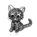 Close-up of a silver-toned cat brooch encrusted with shimmering grey and black crystals - Vintage Silver Black Rhinestone Cat Style