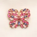 Elegante broche de mariposa con cristales brillantes rosas y morados sobre oro - Rojo