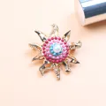 Detailed macro view of a vintage baroque sunburst brooch with pearl and turquoise beads - Flame Sunburst Style / Red
