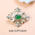 Vintage Baroque style gold brooch with a green oval stone and sparkling crystals - Yellow