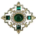 Detail of a vintage Baroque brooch with green gemstones and pearls in a gold openwork design - V015