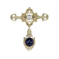Close-up detail of vintage gold Baroque cross brooch with pearl and dark gemstone inlay - V014