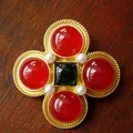 Detailed view of a vintage gold cross brooch with red and green stones - Style F (4.5x4.5cm)