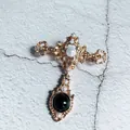 Exquisite detail of luxury Baroque gold-tone brooch with white pearls and black gemstone - Baroque Cross Crown Style (1)