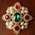 Detailed macro view of vintage palace style brooch with green red gemstones and pearls - Style D Oval Gem (5.2x5.5cm)