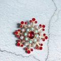 Macro view of a luxury Baroque snowflake brooch featuring red crystals and white pearls - Snowflake Red Main Stone Style (3)