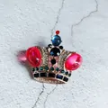 Detailed close-up of a luxury Baroque crown brooch with multi-colored crystals and pink stones - Pink Winged Luxury Crown Style (4)