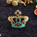 Detailed view of a vintage Baroque crown brooch with red gems and turquoise beads - Baroque Crown (02)