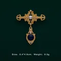 Detailed macro view of a Baroque vintage gold brooch with pearls and blue gemstone. - Hollow Sapphire Teardrop Style (5089421201396)