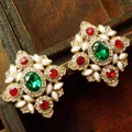 Detailed macro view of vintage palace style brooch featuring colorful green and red gemstones - Earring 1 (3x3.3cm)