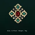 Close-up of Baroque vintage gold brooch with colorful gemstones on dark background - Ruby Core Radial Symmetrical Style (5089421201405)