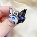 Vintage fox mask brooch with black and white enamel and sparkling blue crystal eyes. - Black and White