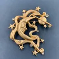 Close-up of an elegant vintage matte gold baroque brooch with moon and star details - Star and Moon (BQ03)