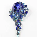 Vintage-style elegant floral brooch with vibrant blue rhinestones and teardrop cluster - Blue
