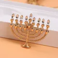 Close-up of a Hanukkah menorah brooch with sparkling rhinestones in gold finish - Menorah Shape (O4-3-5317)