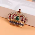 Close-up of elegant crown brooch with colorful rhinestones and green emerald center - Crown Shape (O5-2-5396)