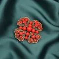 Close-up macro of a vintage heart-shaped brooch with red beads on dark green silk. - Red Cross Floral Style (Style 2)