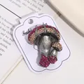 Close-up of vintage mushroom brooch with pink rhinestones on a white card - Vintage Double Mushroom Style